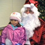 Jenny Arias, 4, tells Santa what she wants for Christmas. Photos/Kathryn Reed