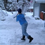 Sue Wood makes shoveling look like a dance move Sunday morning. Photo/Kathryn Reed