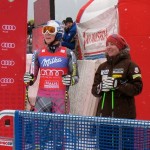 Lindsey Vonn and Stacey Cook watch the big screen as teammate Julia Mancuso burns to an 11th place finish in the second Haus im Ennstal downhill. Photo/Doug Haney/U.S. Ski Team)