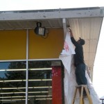 Shane Guzman works on the exterior of the Do It Center this week. Photos/Kathryn Reed