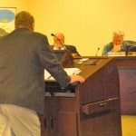 Councilman Bruce Grego, standing, defends his actions as colleagues Jerry Birdwell and Hal Cole listen. Photo/Kathryn Reed