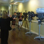 Principal Ivone Larson takes a photo of students by old film cameras. Photo/Provided