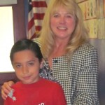Jesse Preciado, third-grader in Brenda Capshaw's class, receives an award from Laurie Brazil. Photo/Provided     