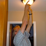 Sten Seemann checks to see the type of bulbs in this fixture. Photos/Kathryn Reed