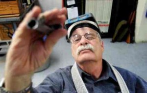  Brian van der Brug / Los Angeles Times Gunsmith Terry Tussey checks details on a 1911 pistol barrel at his bench, March 26, 2013, in Carson City. Tussey moved to Nevada when he realized that gun legislation in California would affect his business. At 73, he is one of the most reputable gunsmiths in the West, practicing a vanishing craft.