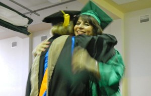 Georgillis Ortega receives a congratulatory hug from President Kindred Murillo.