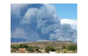 A plume of black smoke rises July 7 from the Bison Fire.