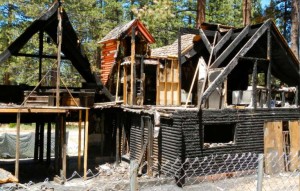 A 6-foot cyclone fence surrounds the remains of Peter Darvas' house that was destroyed by fire in September 2012. Photo/LTN