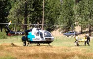 Rescue crews take an injured hiker July 7 to the Calstar helicopter. Photo/Damian Frisby