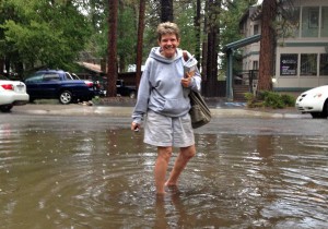 Rosemary Manning can't avoid getting wet as she walks to her vehicle at Blue Angel Cafe in South Lake Tahoe Aug. 25. Photo/Kathryn Reed