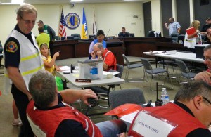 South Lake Tahoe Fire Chief Jeff Meston, standing, checks in at the emergency operations center.