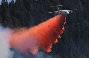 A jet aerial tanker drops its load of fire retardant on a fire near Pollack Pines, Calif., Monday, Sept. 15, 2014. The fire, which started Sunday has consumed more than 3,000 acres and forced the evacuation of dozens of homes. (AP Photo/Rich Pedroncelli) Photo: Rich Pedroncelli, Associated Press