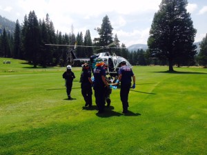 First responders take an injured cyclist to the air ambulance. Photo/Provided