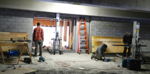 A construction team works at the third floor parking garage entrance to The Loft.