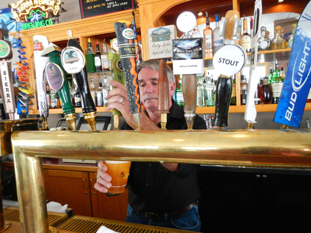 Mark the bartender pours one of the 13 beers that are on tap. Photo/Kathryn Reed