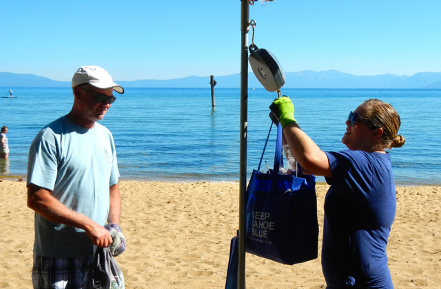 Gina Hunt with the League weighs the trash Greg Psilopholos collected. Photo/Kathryn Reed