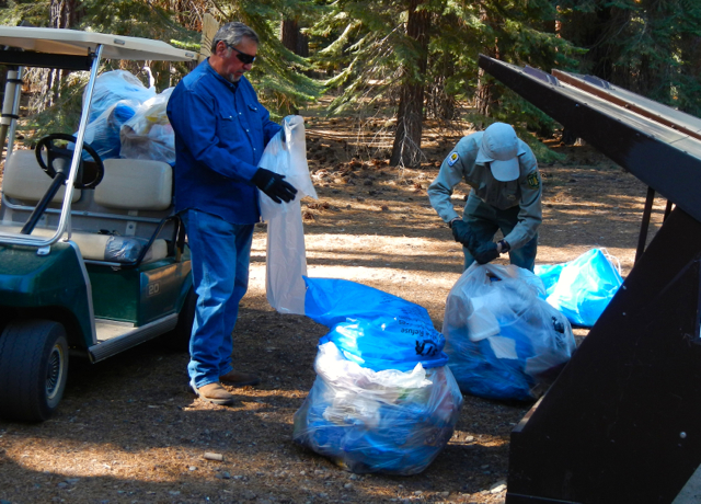 Paul Cleveland and Matt Diamond empty the trash from the bear boxes on July 5 at Kiva. Photo/Kathryn Reed