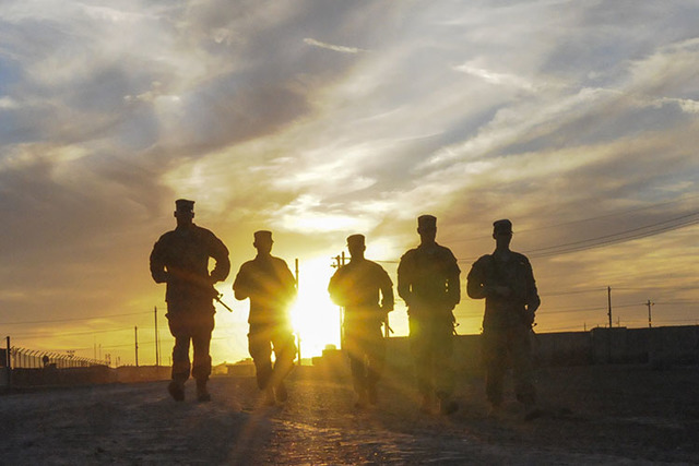 Soldiers walk along a road in Taji, Iraq. Photo/Staff Sgt. Victor Joecks/U.S. Army National Guard