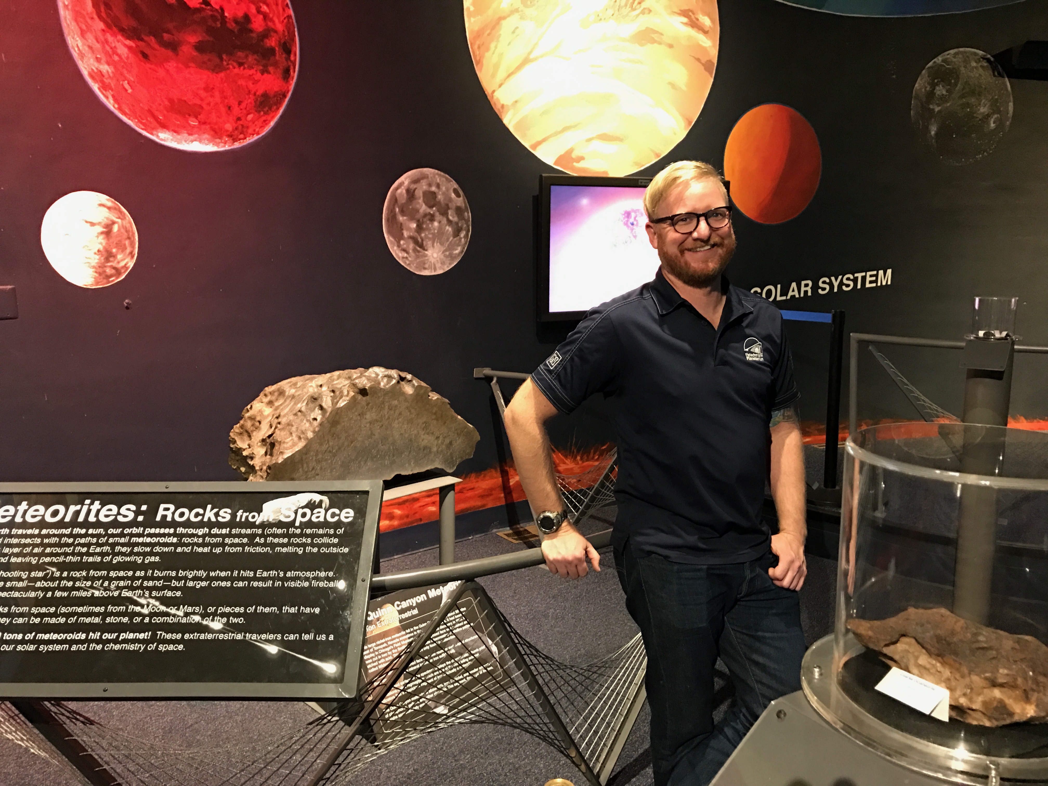 Dan Ruby, planetarium director, at the Meteorite exhibit. Photo/Tony Berendsen