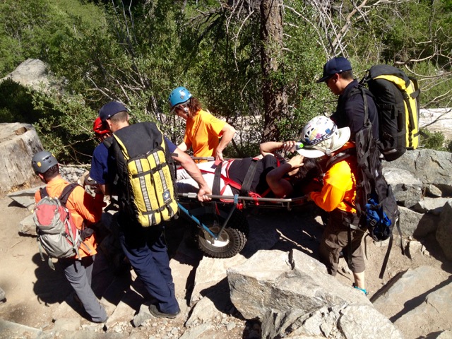 A hiker who suffered a foot injury this summer at Eagle Falls is carried to the trailhead. Photo/Provided