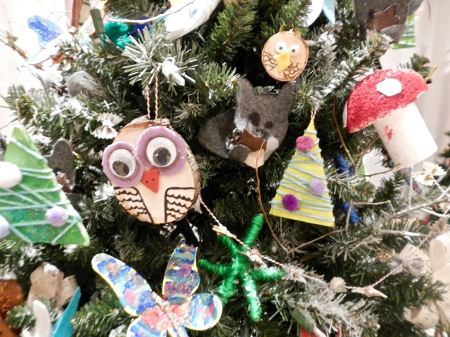 Ornaments crafted by children adorn the school trees.